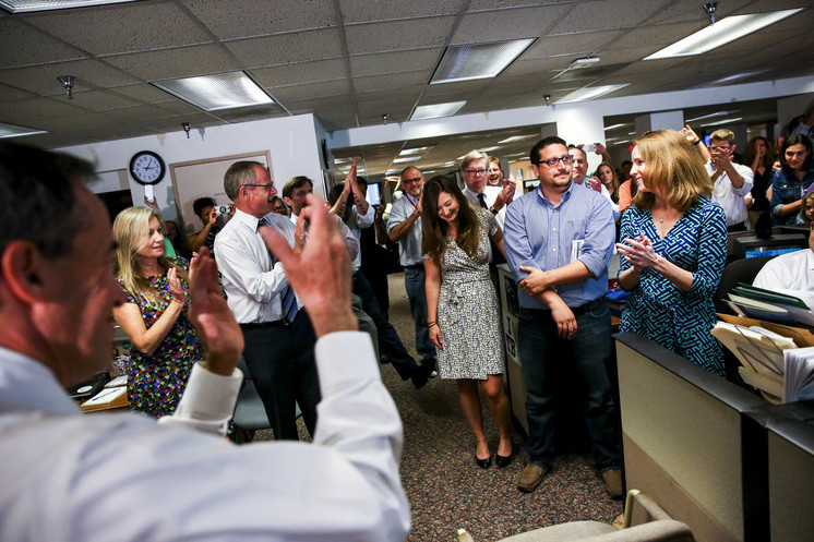 Cara Fitzpatrick (right), Michael LaForgia and Lisa Gartner of the Tampa Bay Times are applauded after the announcement that their work had won a Pulitzer Prize on Monday.